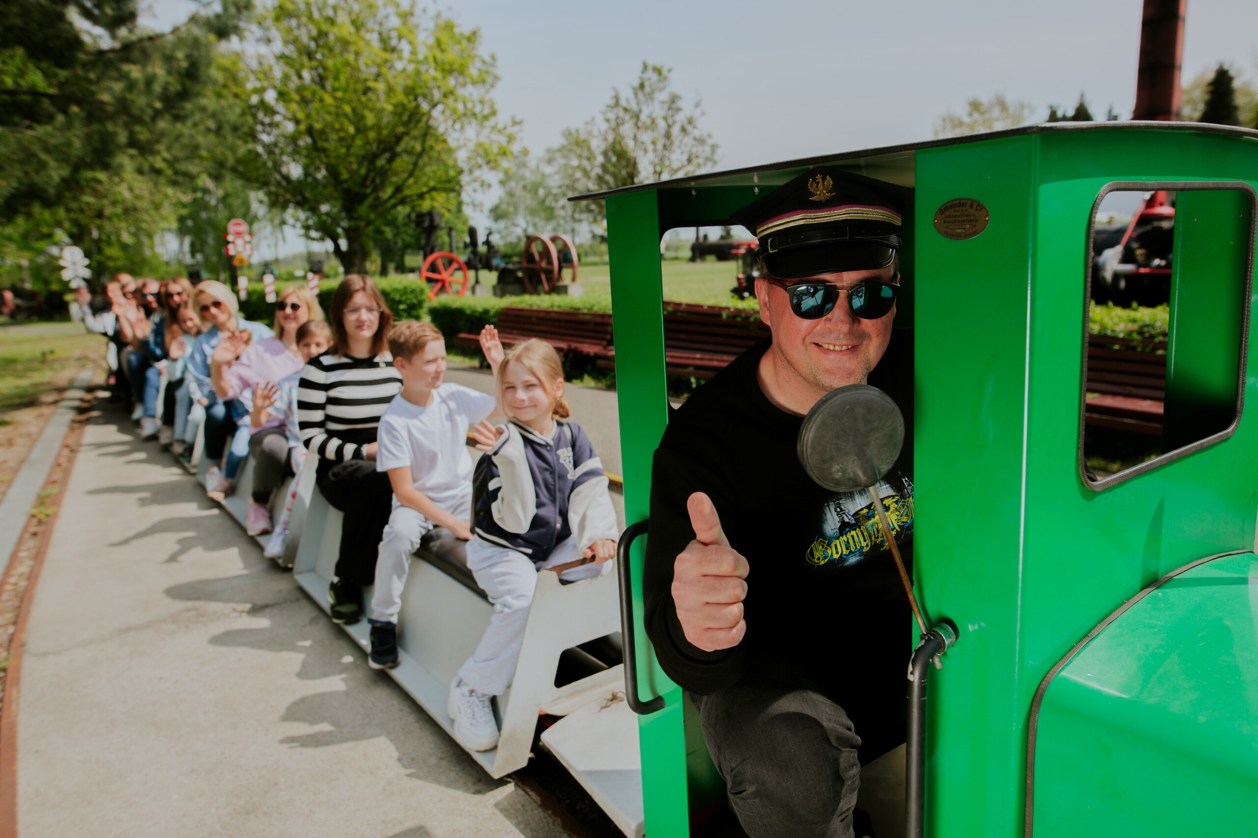 Ludzie jadący kolejką w Skansenie Maszyn Parowych
